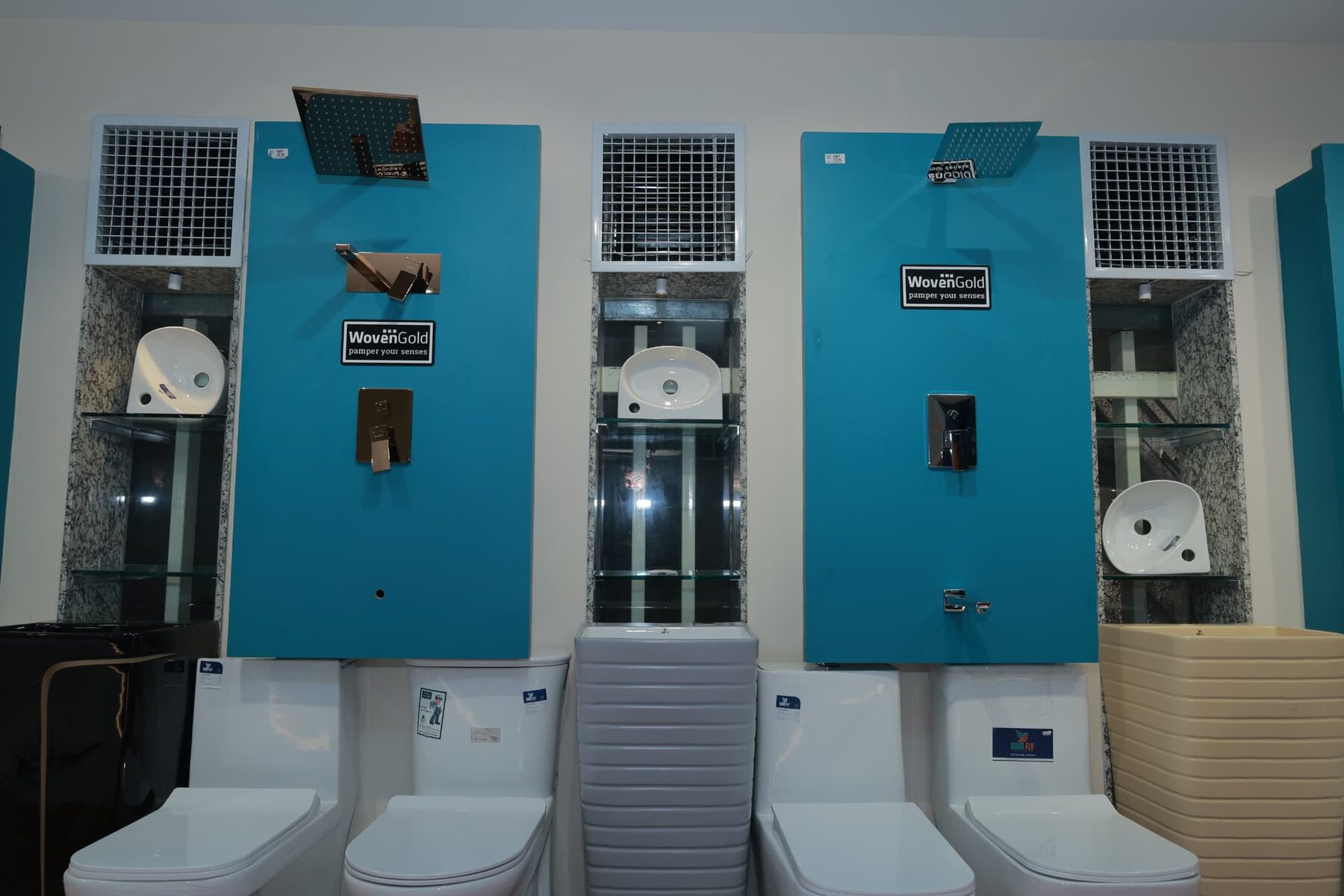 Woven Gold overhead showers, concealed diverters and one-piece water closets